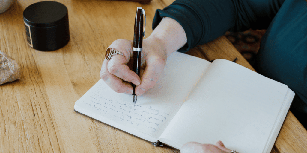 Conquer Limiting Beliefs After 40: Journaling Technique. A woman writing in a journal